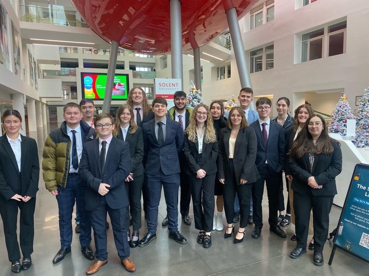 Group of young students in suits