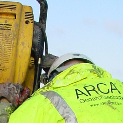 Archaeology contract research at Winchester: geoarchaeologist in high-viz jacket drilling a borehole