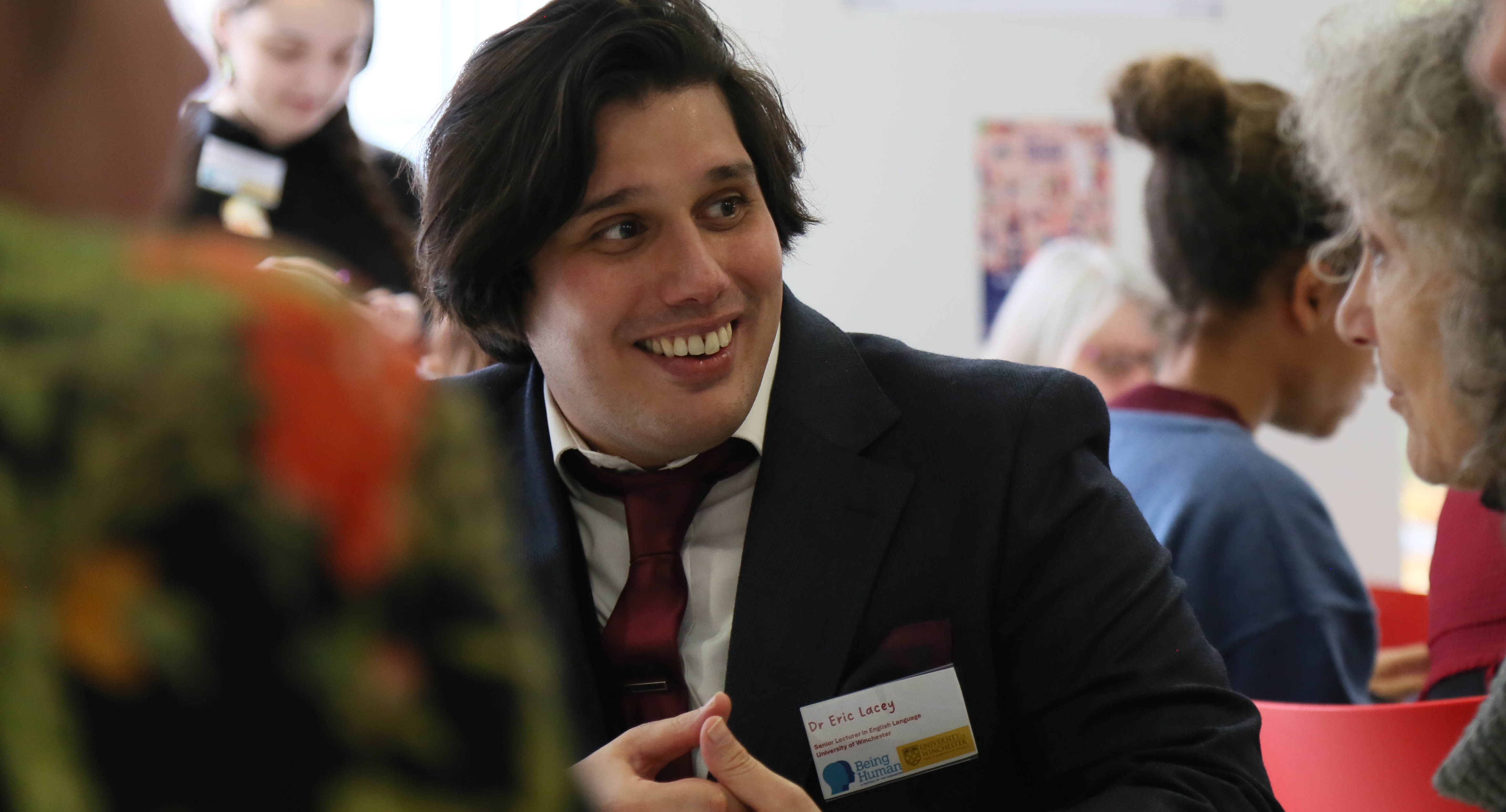University of Winchester linguist Dr Eric Lacey smiling while talking to members of the public at an event