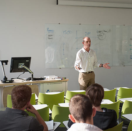 Lecturer and students in lecture room