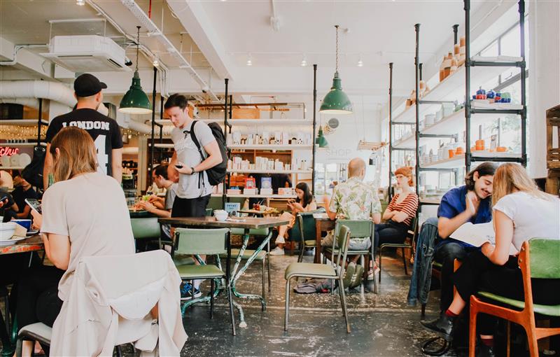 A group of people socialising in a cafe