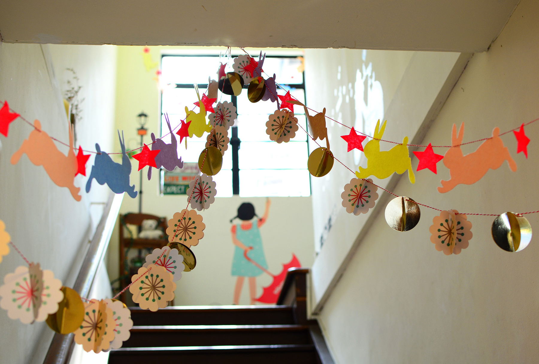 Staircase with banners and a painting of a child