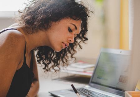 Student sitting at desk taking notes