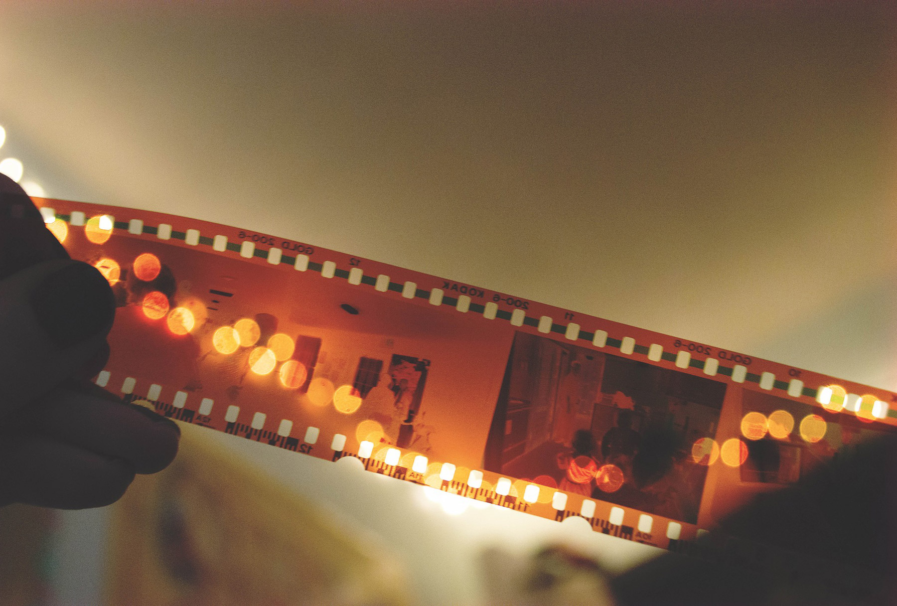 Person holding film tape up to a light
