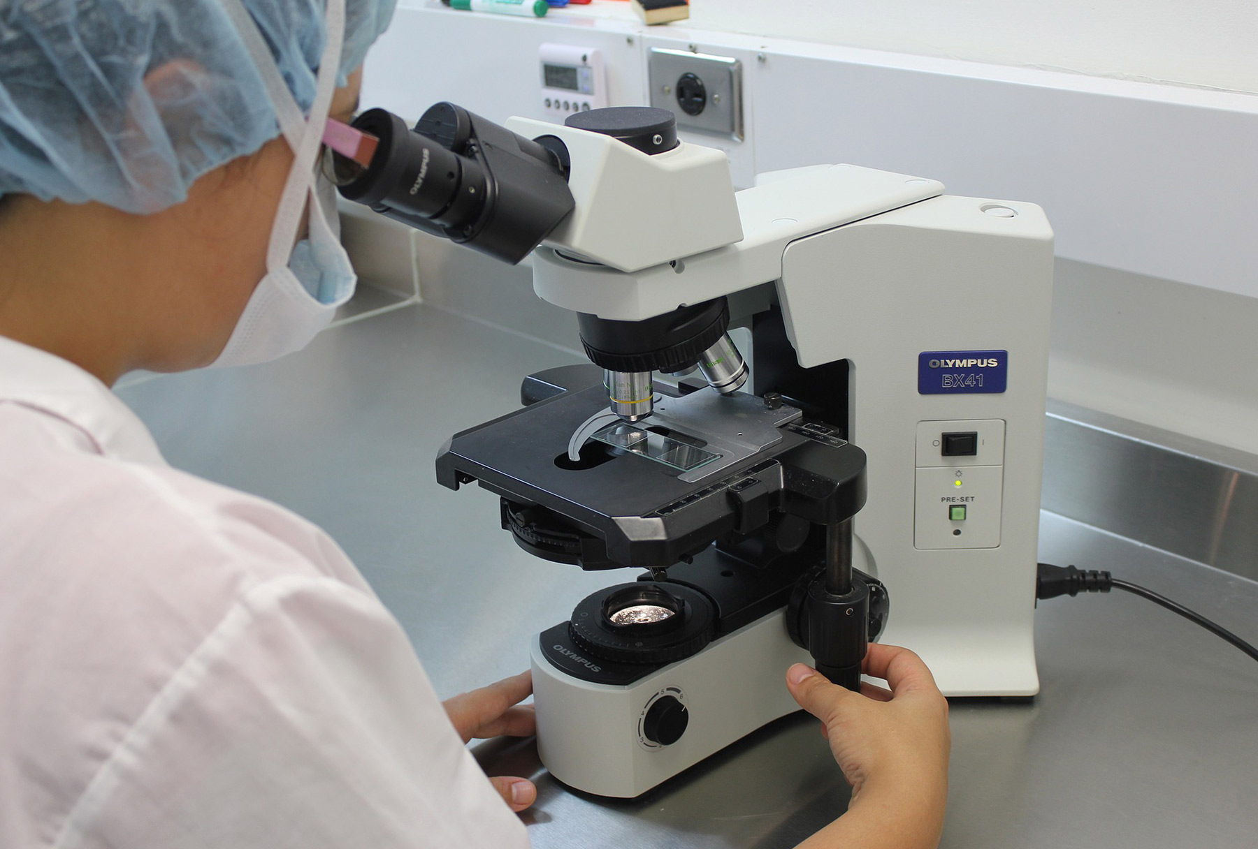 Student looking through a microscope