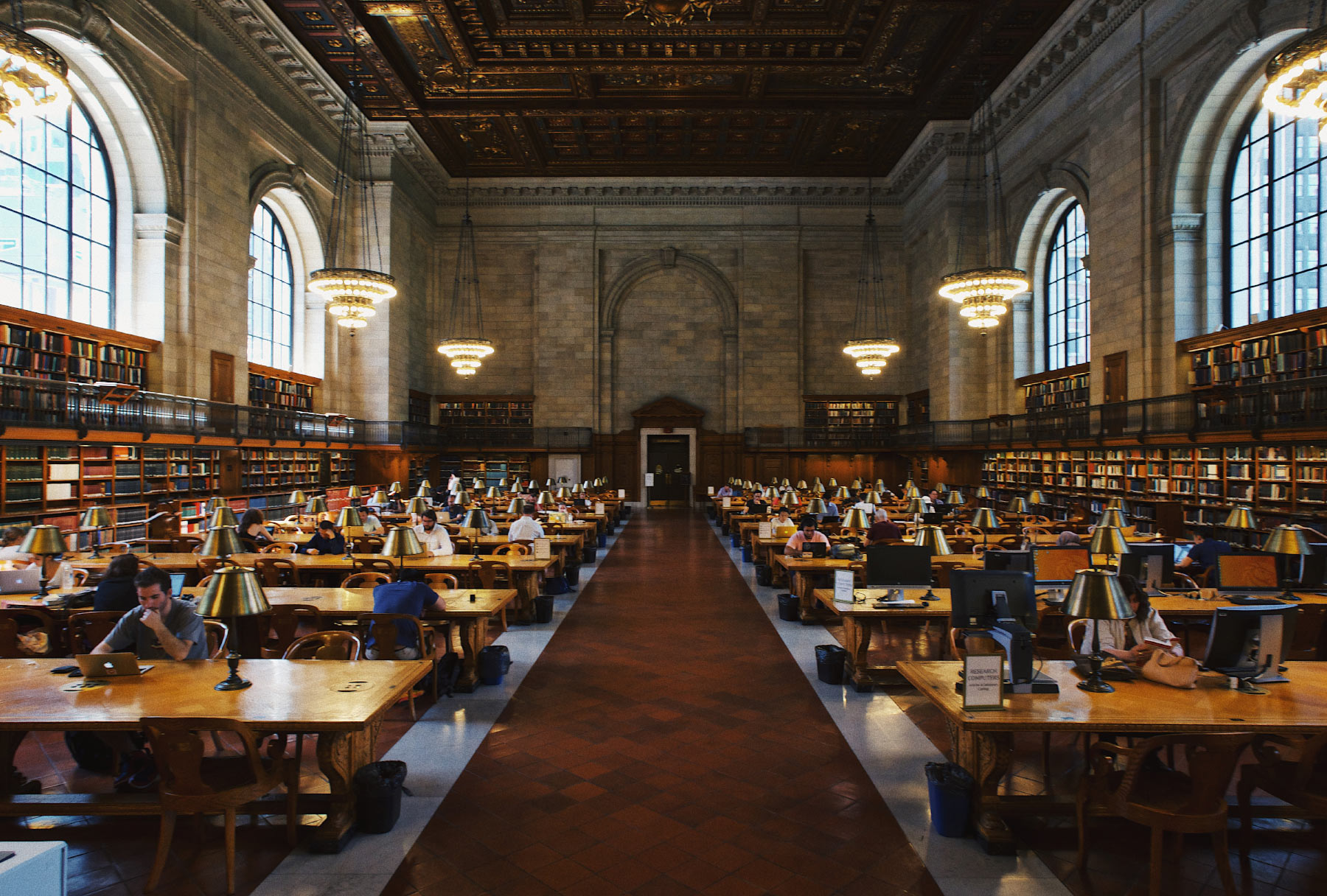 Students studying in a library hall