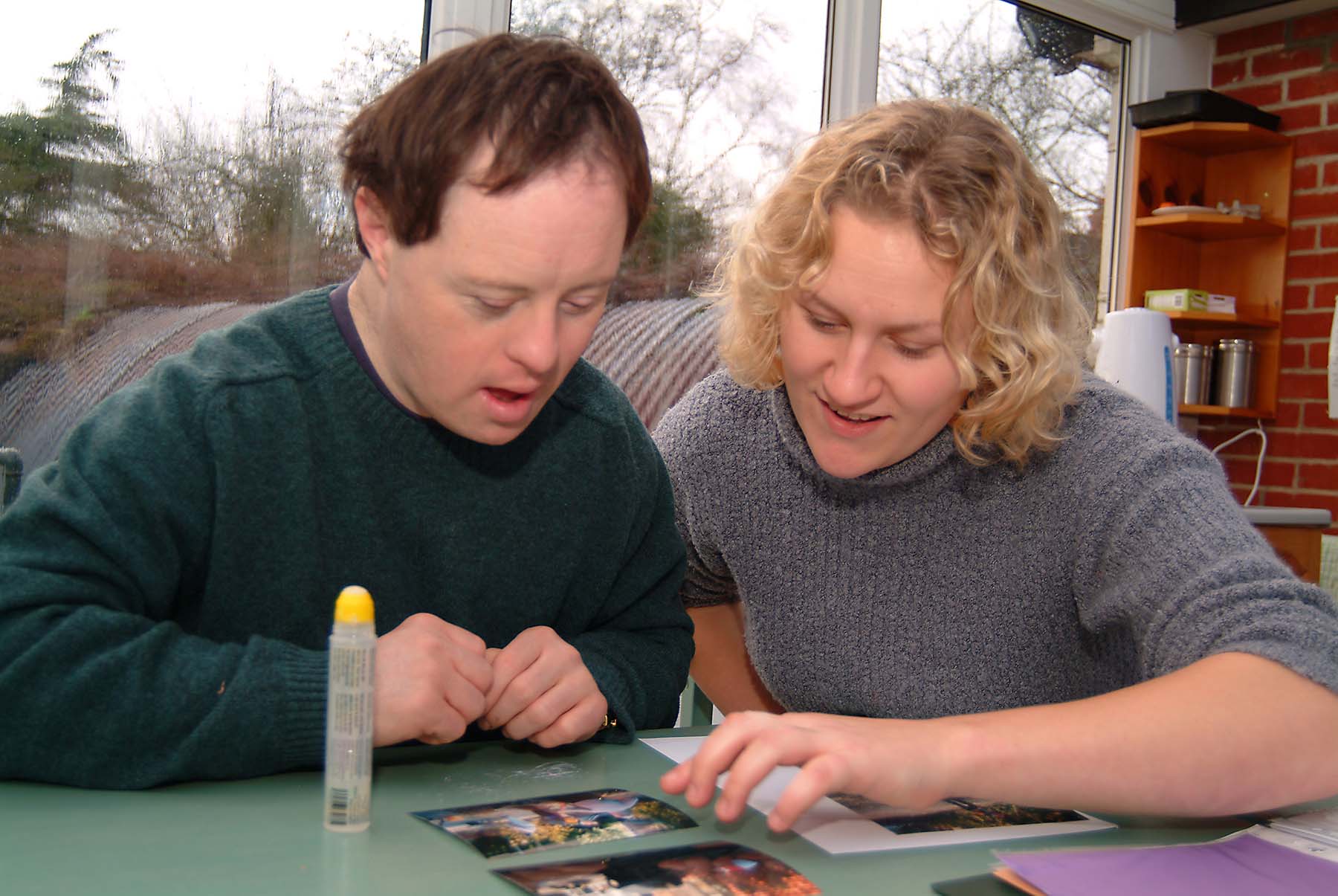 Carer and man arts crafts table