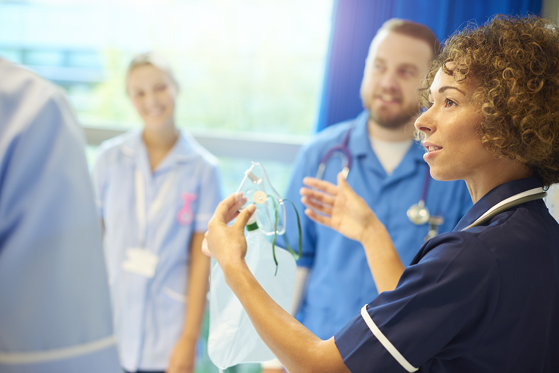 three nurses in a hospital setting