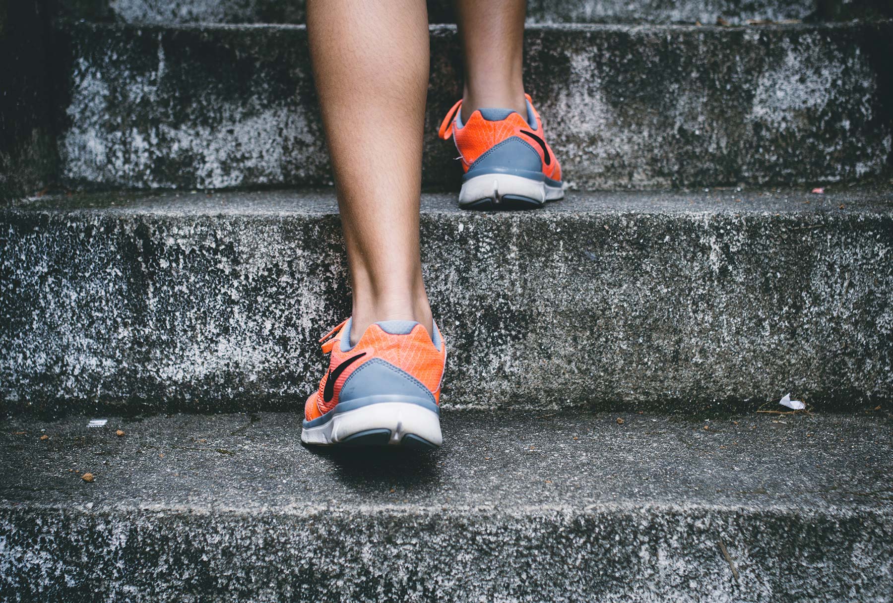 Someone in running trainers running up some stairs