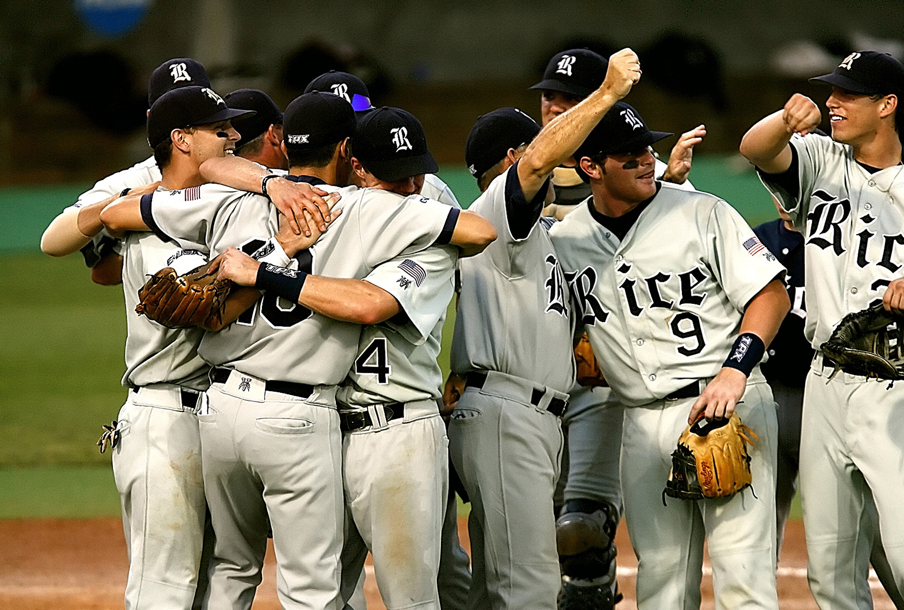 Baseball players hugging on a baseball field