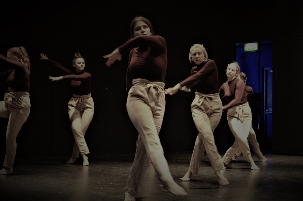 Group of students dancing in a performance studio