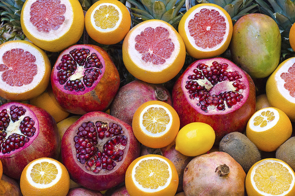 Pomegranate and orange fruit cut open