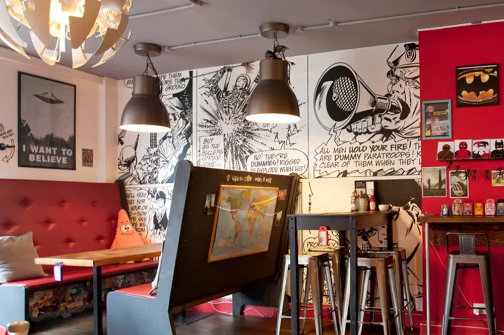 Inside of a cafe with comic book designs on the walls