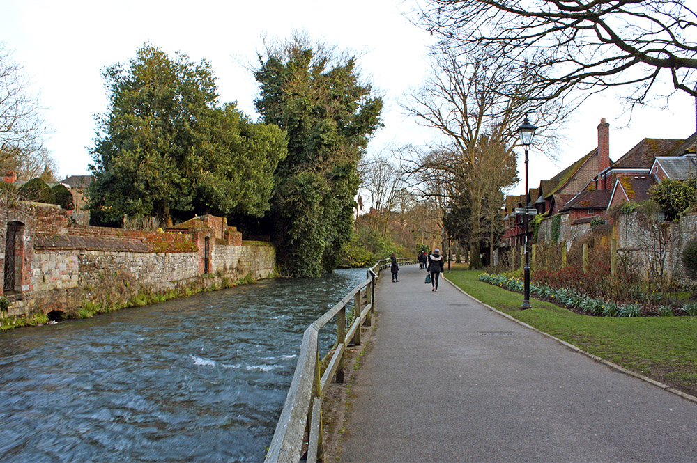 Old brick wall with a river and path