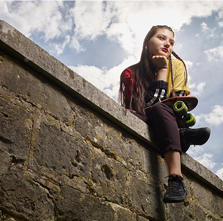 Student sitting on a wall