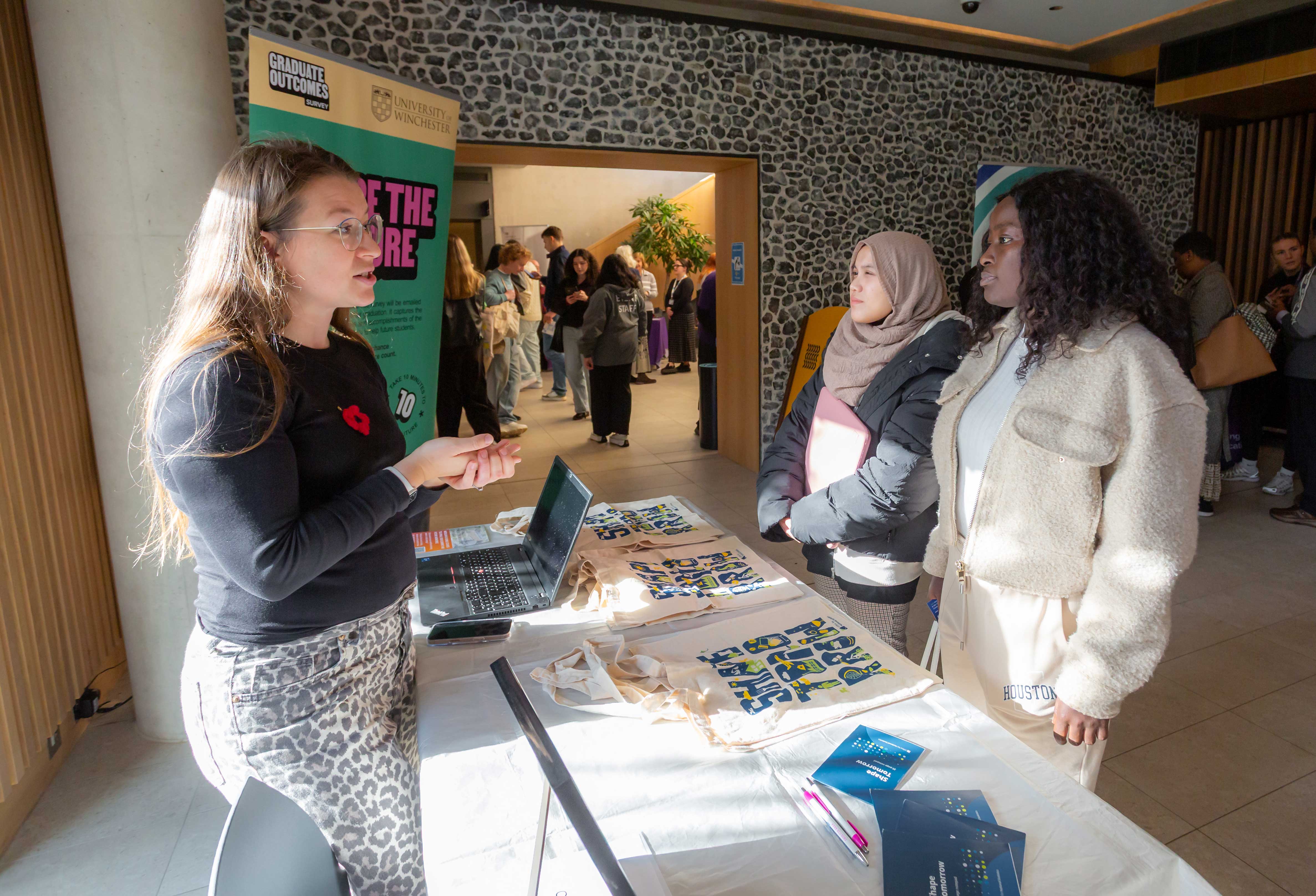 Students talk to a stallholder at a careers event