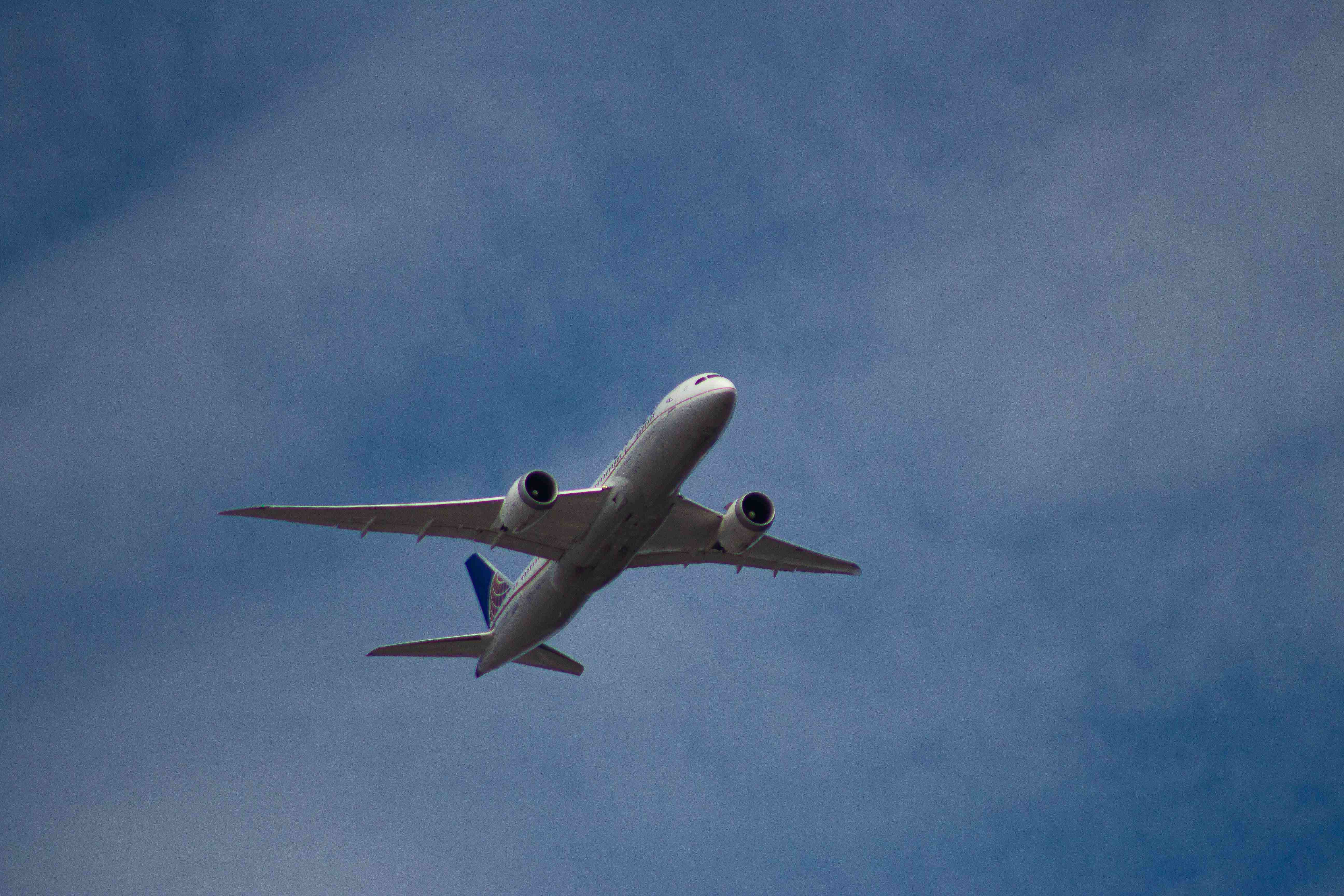 A plane flying against a blue sky