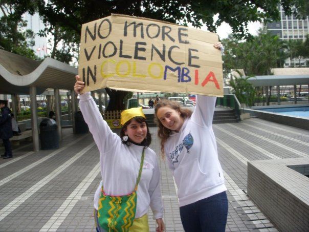 Two girls holding up placard calling for an end to violence in Colombia