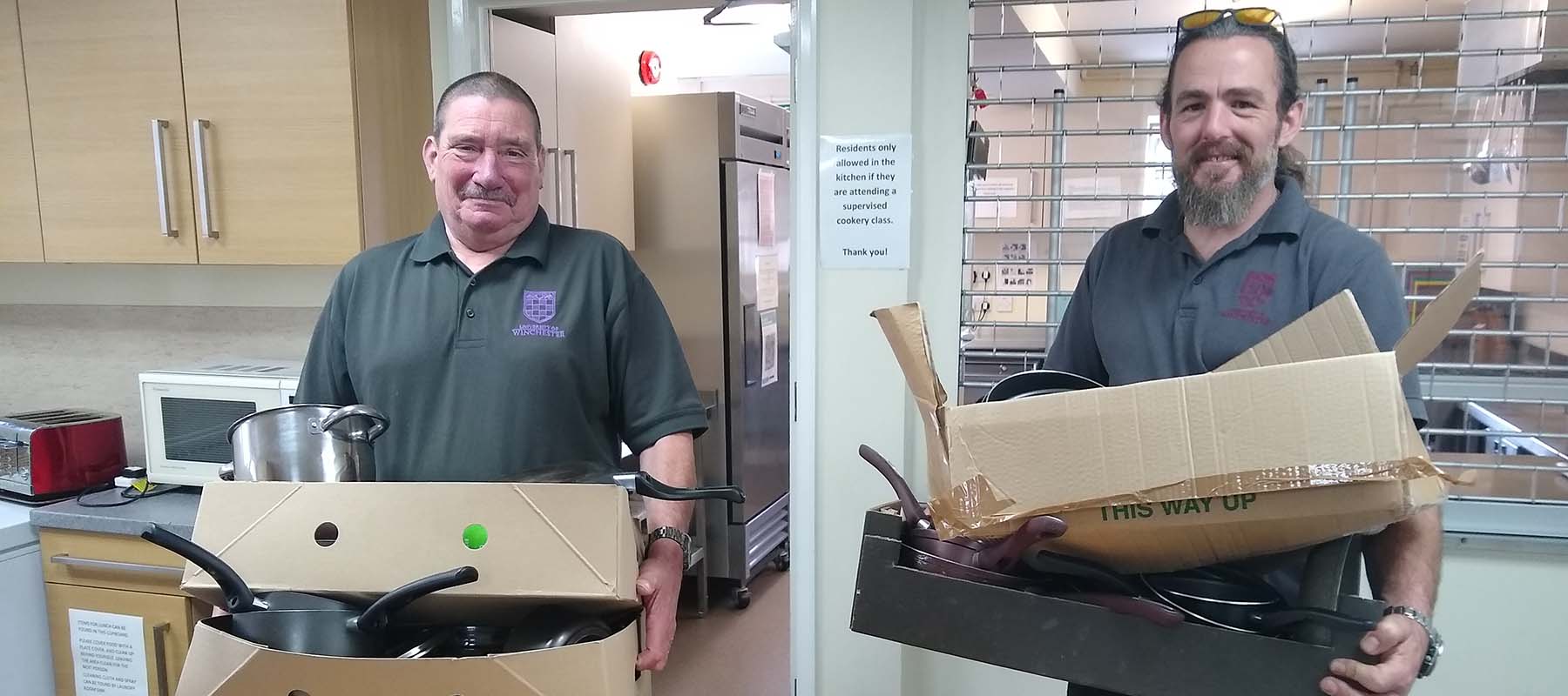 University porters with boxes of donated kitchen ware