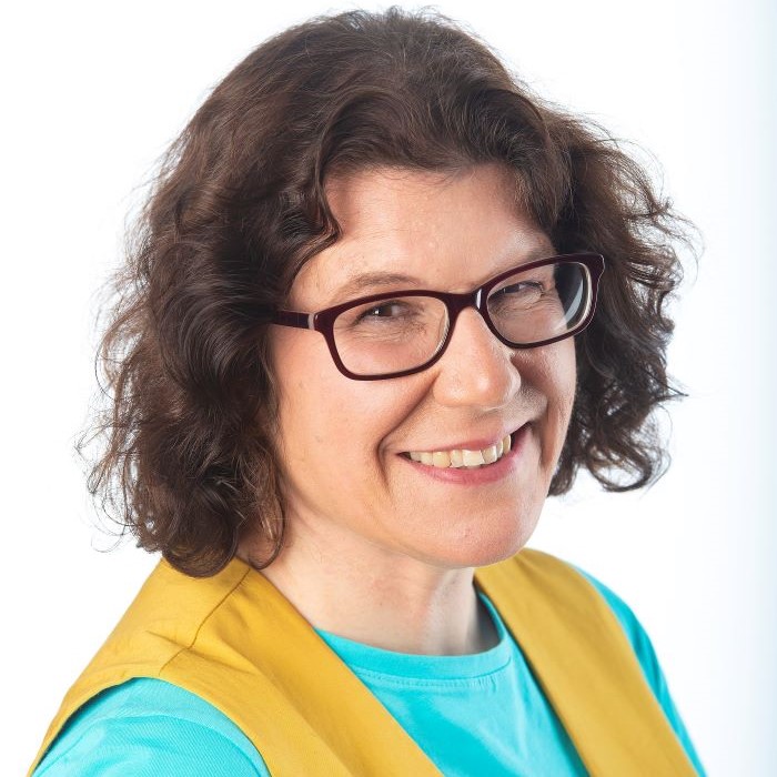 Woman with glasses and yellow waistcoat