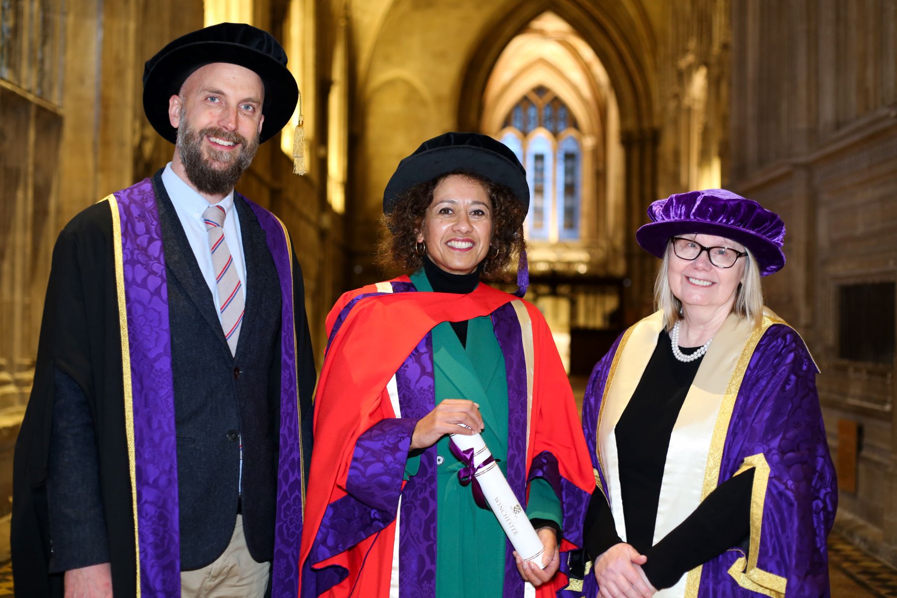 Man and two women in academic robes
