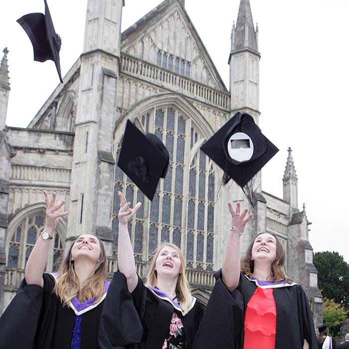 Students celebrating graduation outside the Cathedral