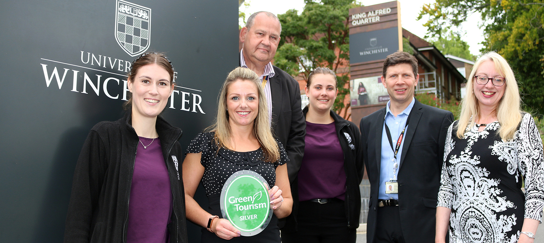 Conferencing and catering staff with their green Tourism Silver Award outside the University