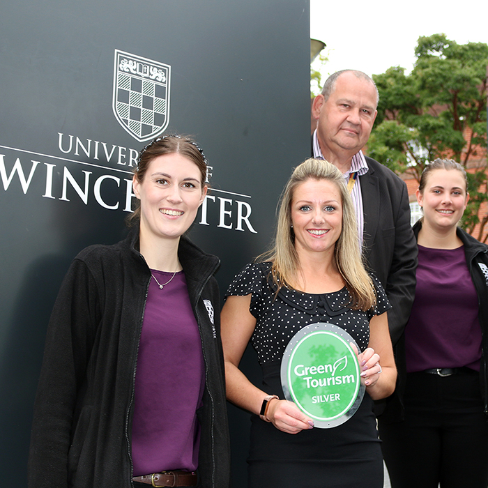 Conferencing and catering staff with their green Tourism Silver Award outside the University