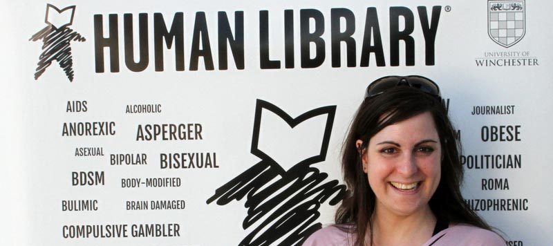 Human Library post-Apartheid poster with young woman in pink t-shirt