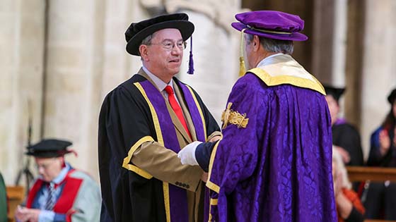 Kevin in ceremonial robes shakes Alan Titchmarsh's hand during the ceremony