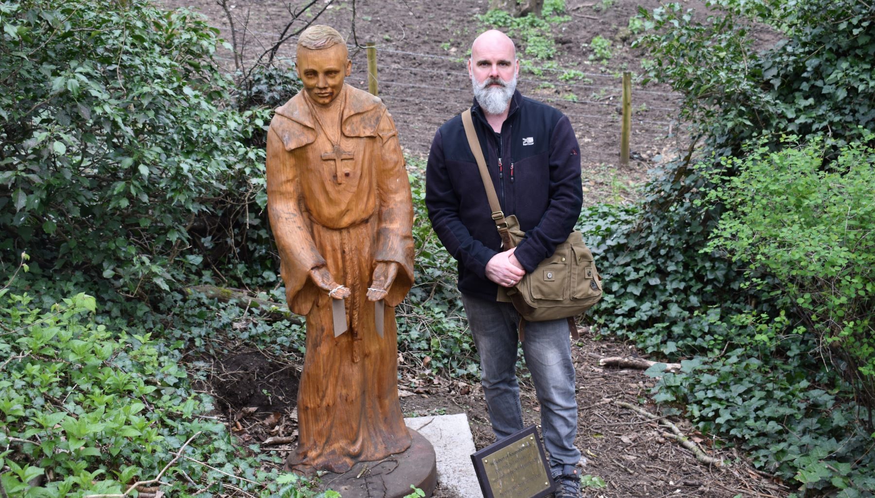 Man with statue of saint