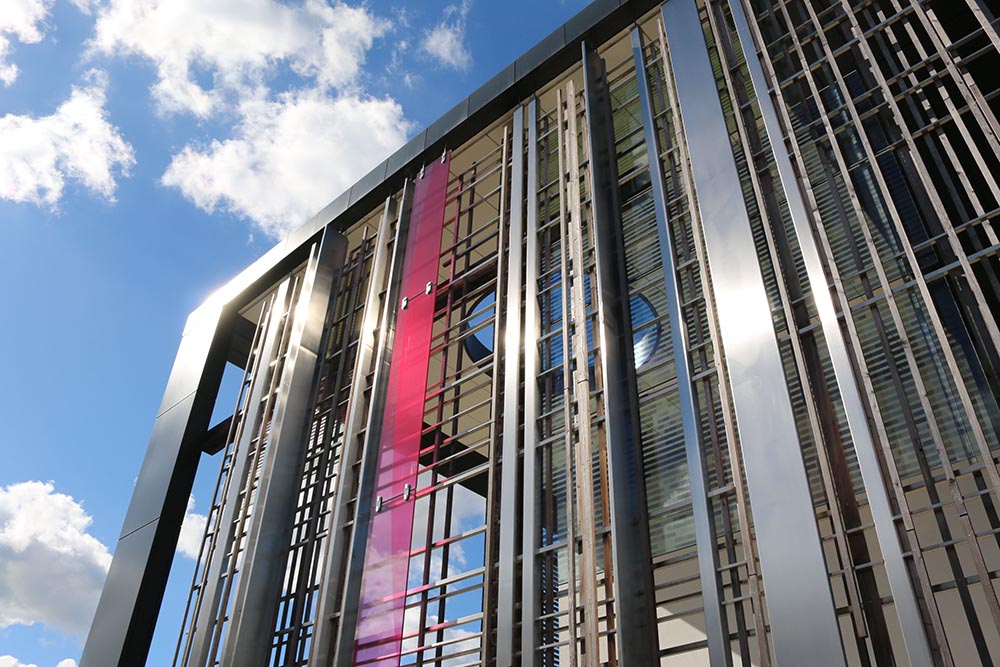 Exterior of steel clad campus building against a blue sky