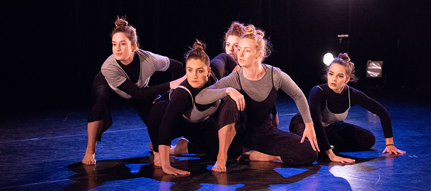 Five female contemporary dancers performing