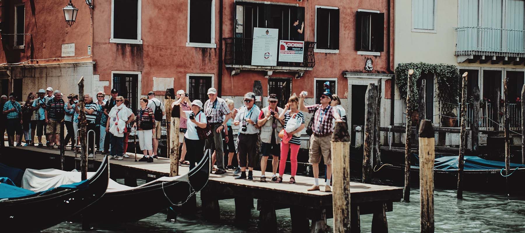 Tourists by a canal in Venice