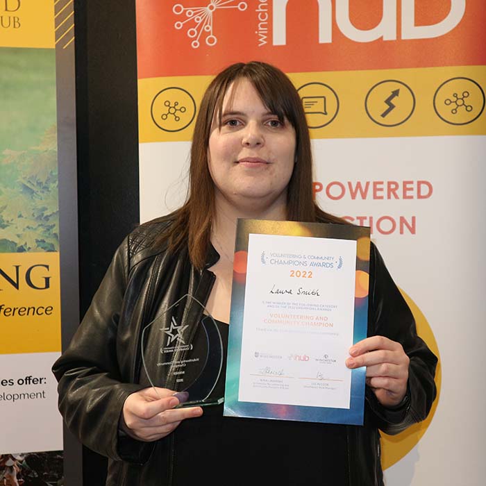 Laura Smith holding her winners award