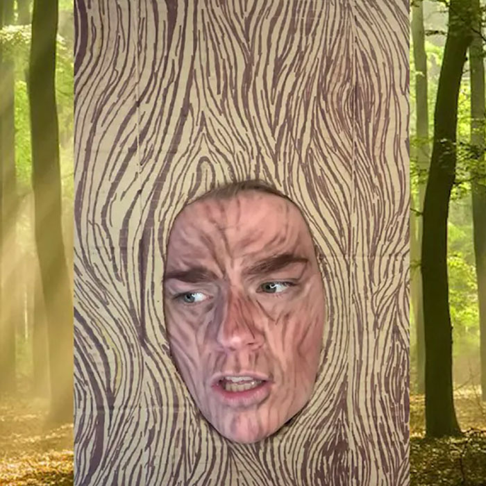 Two students facepainted to look like tree trunks