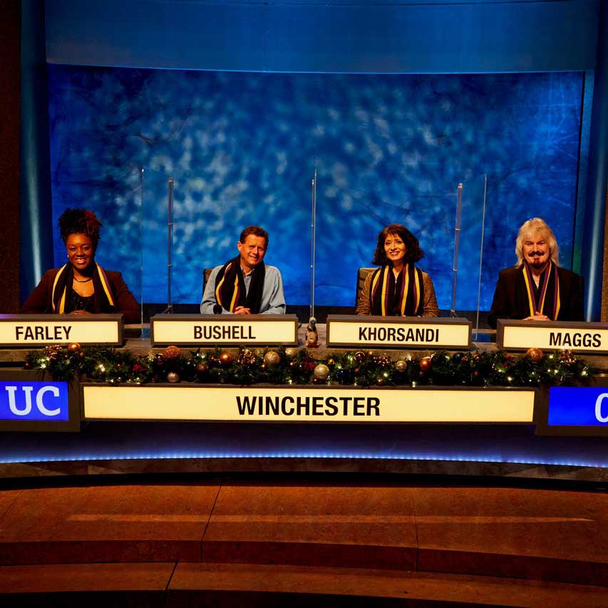 The Winchester team on set behind the desk