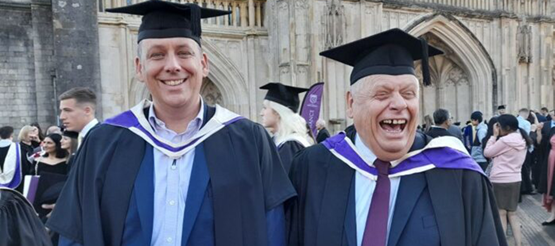 MIke Cranston outside Winchester Cathedral with his son Paul at their Graduation