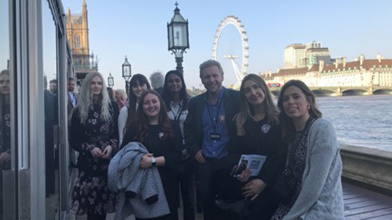 Students on terrace with view of london eye