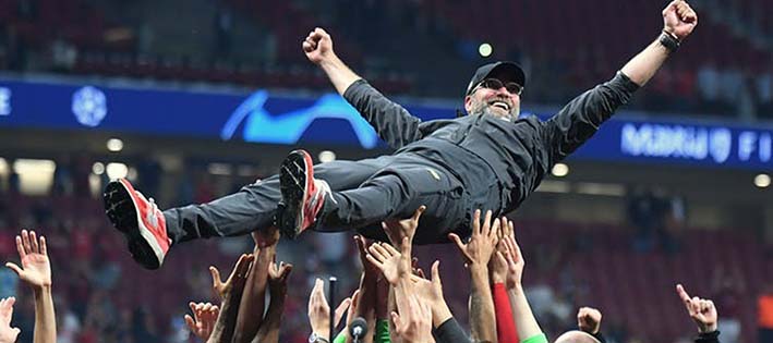 Jürgen Klopp, Manager of Liverpool Football Club, crowd-surfs raised up by team