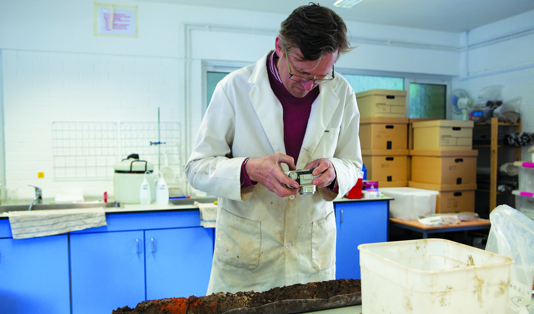 Geoarchaeology at Winchester: Geoarchaeological Consultant Nick Watson photographing a soil sample in the laboratory